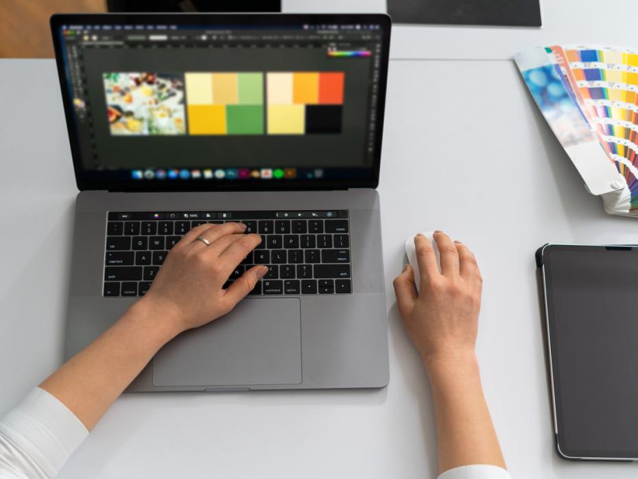 A teacher designing an infographic on her laptop