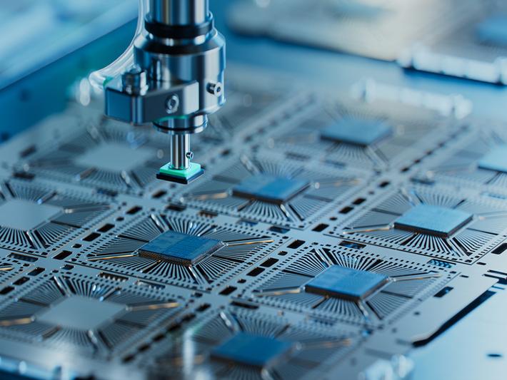 Close-up of silicon die are being extracted from semiconductor wafer