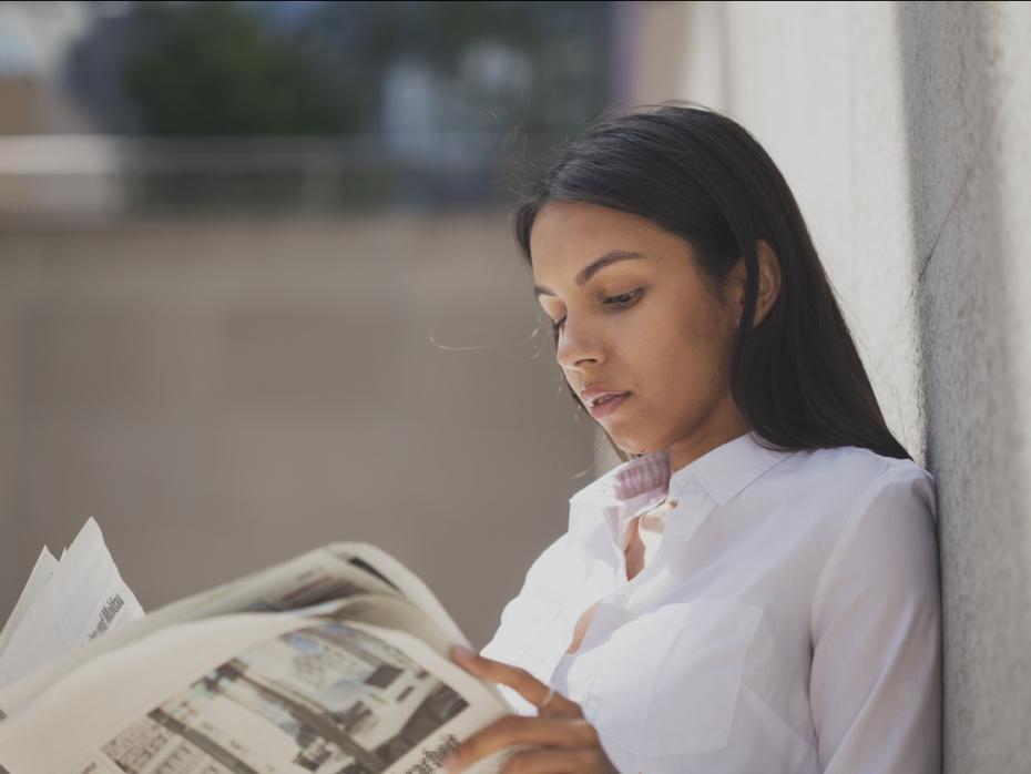 A student reading a newspaper