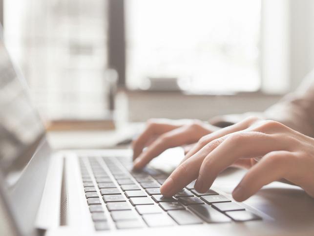 Fingers typing at a keyboard