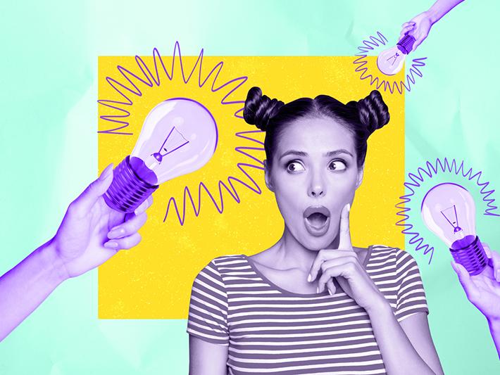 Young woman surrounded by light bulbs, creative concept