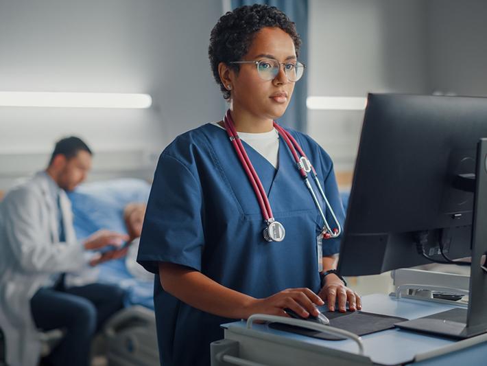 Nurse entering information into computer