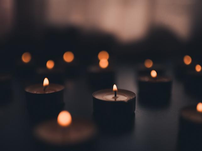 Lit candles in a darkened room