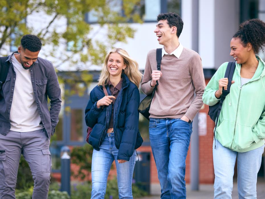 Students walking through campus laughing