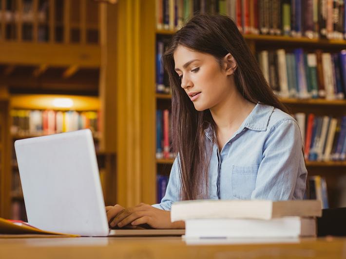 Young scholar working in library