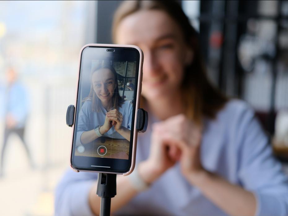 A student filming herself on her phone