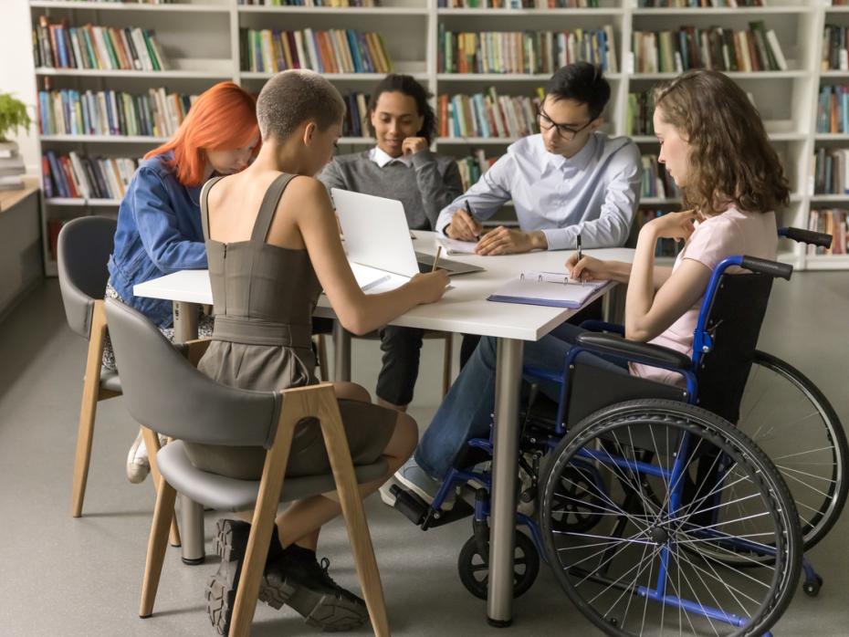 A group of students working on a project together in a classroom