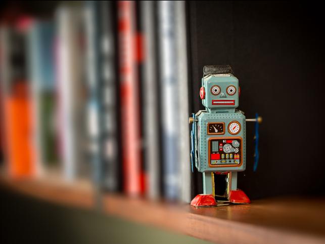 A toy robot stands on a shelf