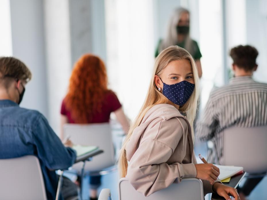 Students wearing a mask in class to protect against viral infection