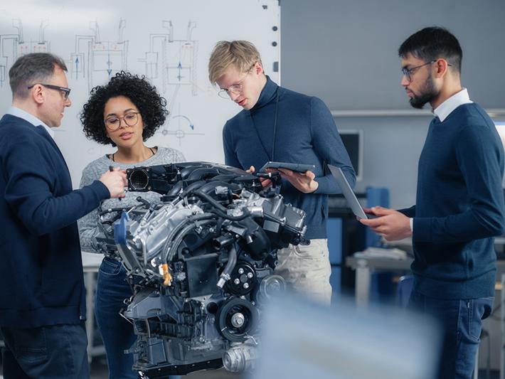 Team of engineers working on an engine