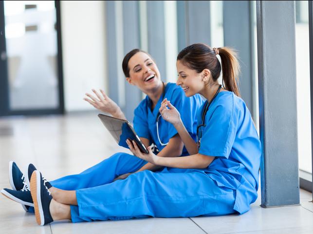 Nurses laugh with an iPad