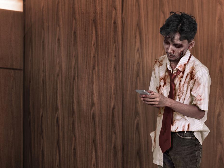 A student zombie scrolling social media on his mobile phone