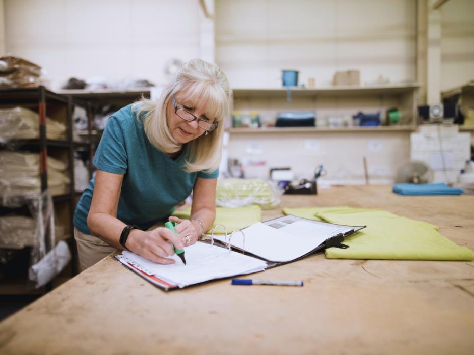A professor marking work at her desk