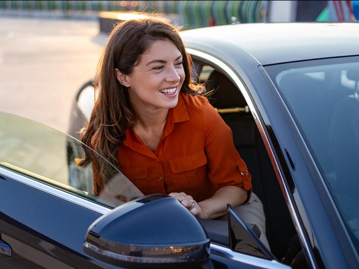 Woman getting out of car