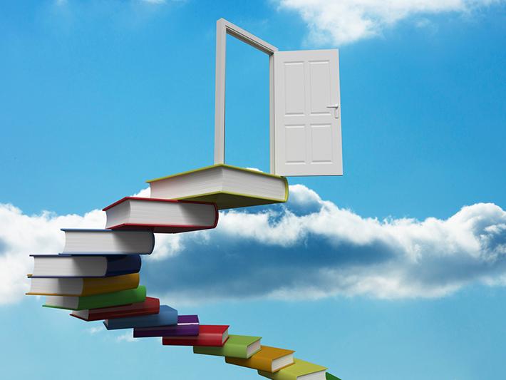 Stairway of books leading to open door