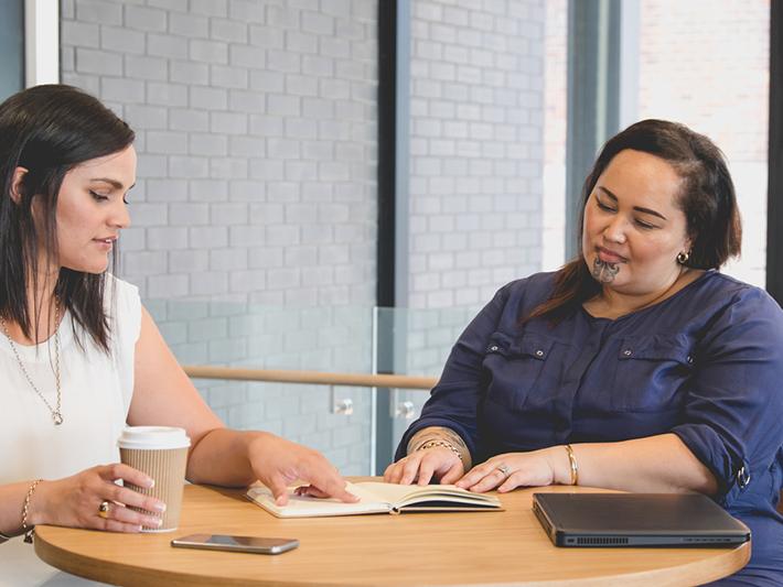 Two Maori women in a meeting