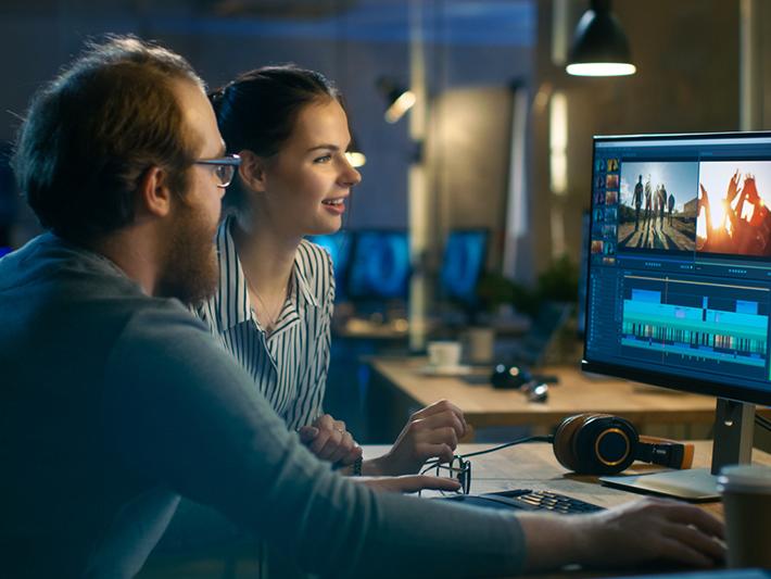 Man and woman working on film editing