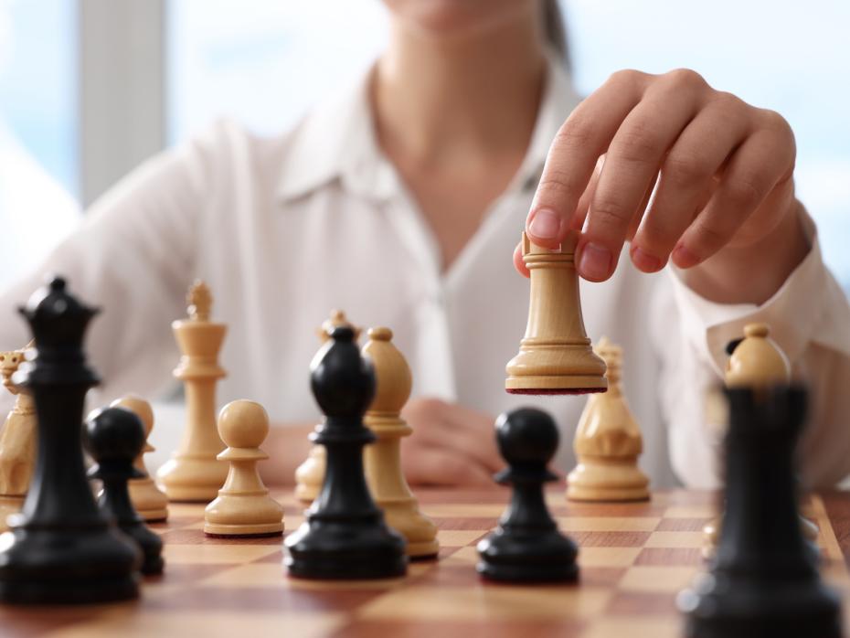 A chess player moving a rook across the board