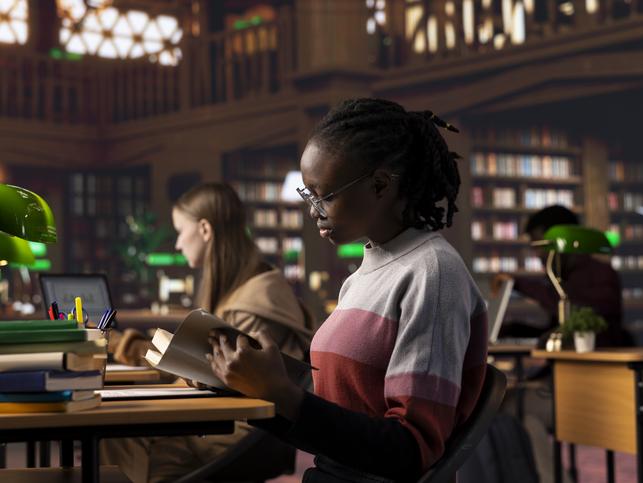 A young woman studies in a library
