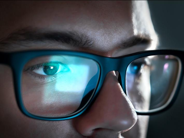 Close up on young woman looking at computer screen