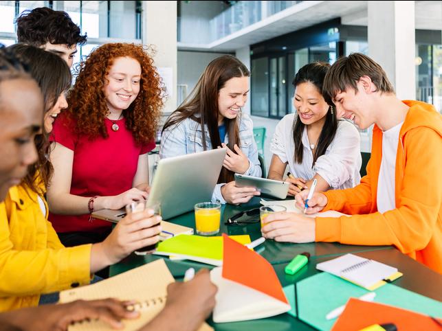 Students work on a project round a table