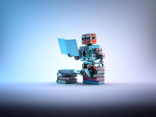 A toy robot sits on a stack of books