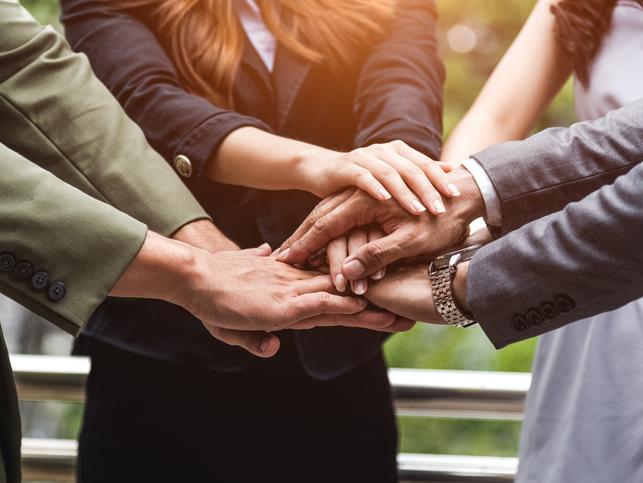 Business people clasp hands