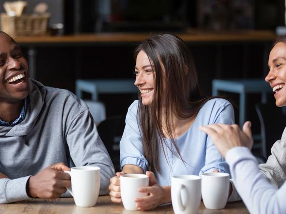 Students laugh over a coffee