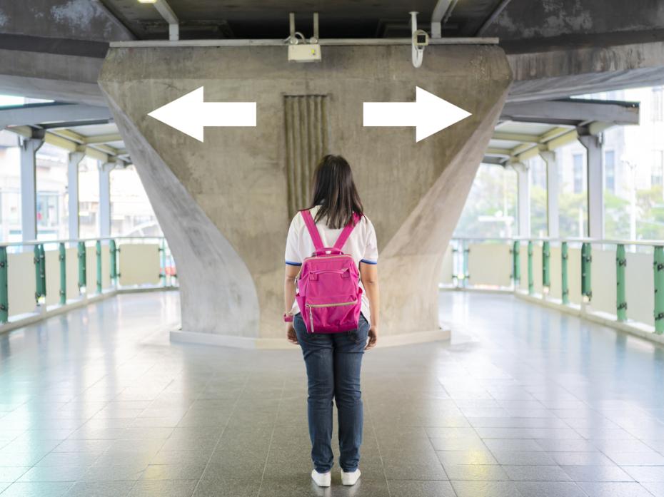 Someone standing at a crossroad, unable to make a decision