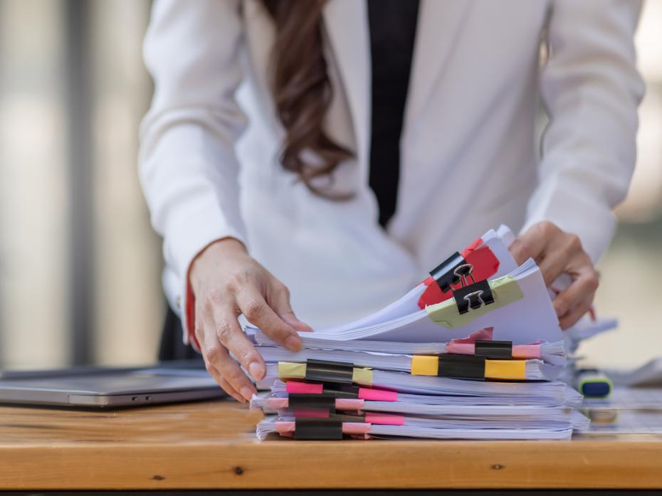 A teacher going through a pile of papers