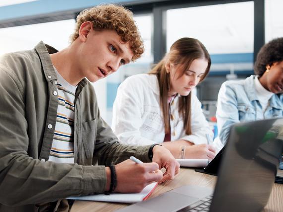Students work together round a table