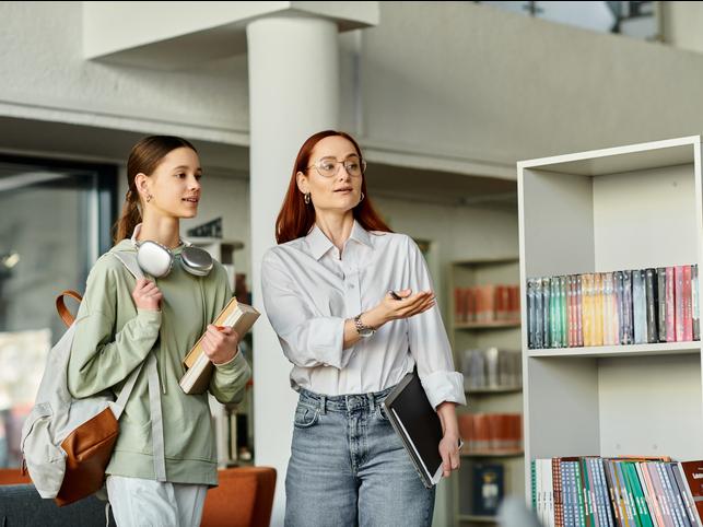 A librarian guides a student