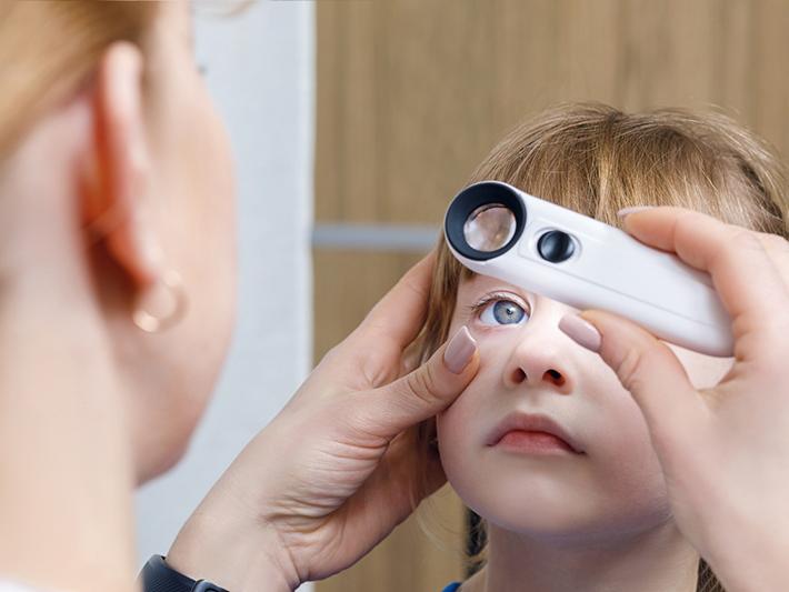 ophthalmologist examining a child's eye