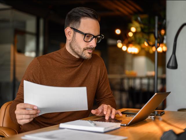 A researcher works at a laptop