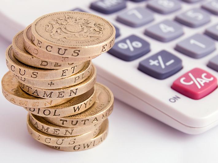UK pound coins and a calculator