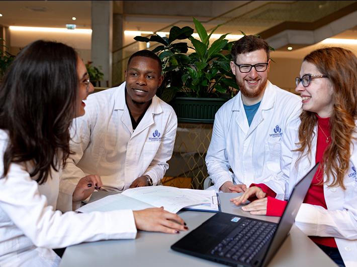 Medical students in discussion around a table