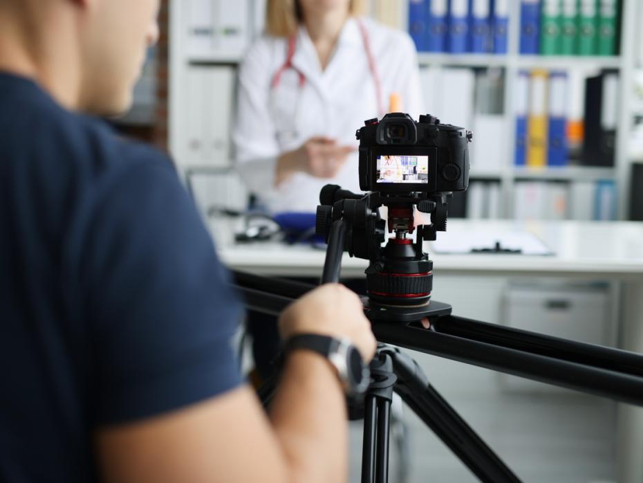 Close up of a camera as it films an instructor explaining a medical concept