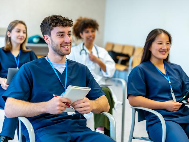 Medical students learn in a small session