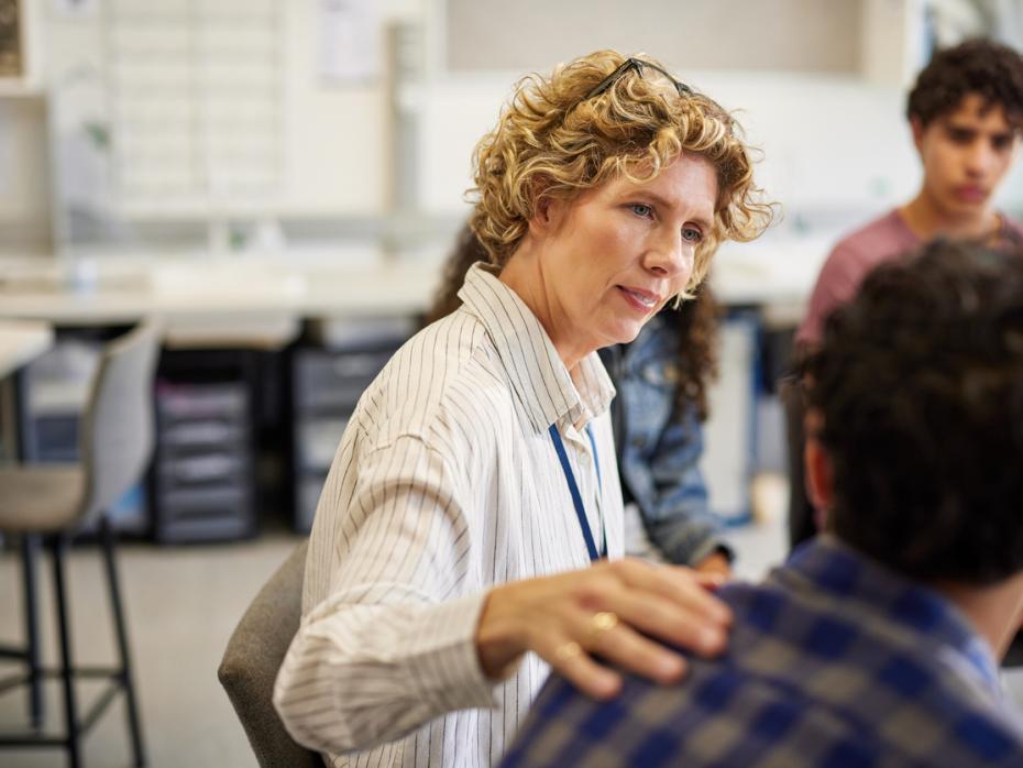 A teacher comforting a student in class