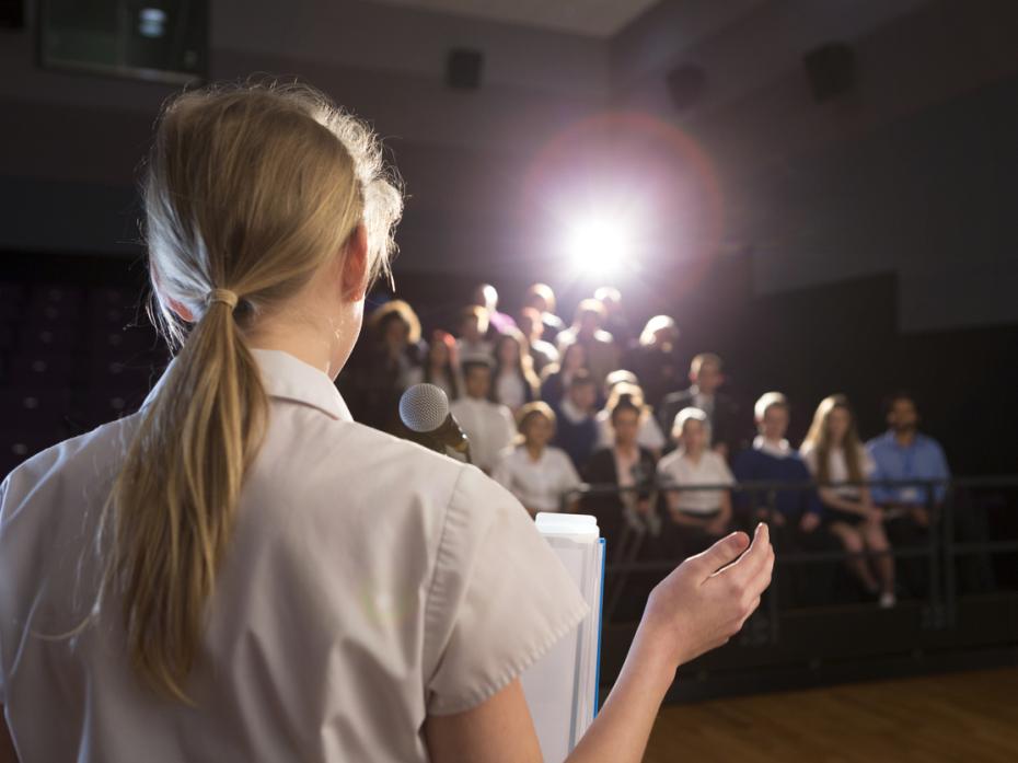 A student giving a presentation in front of other students