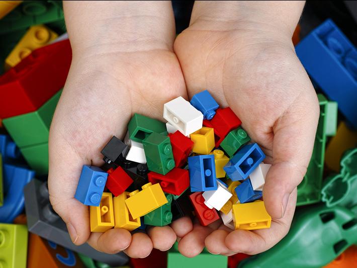 Child's hands holding Lego bricks