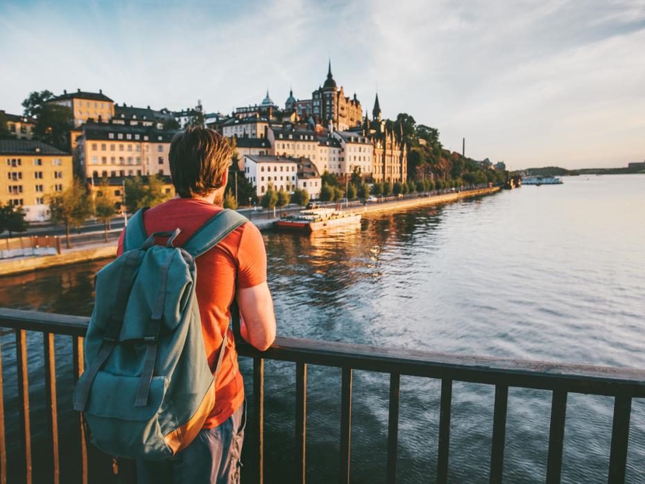A young man admiring a view from a bridge in Stockholm
