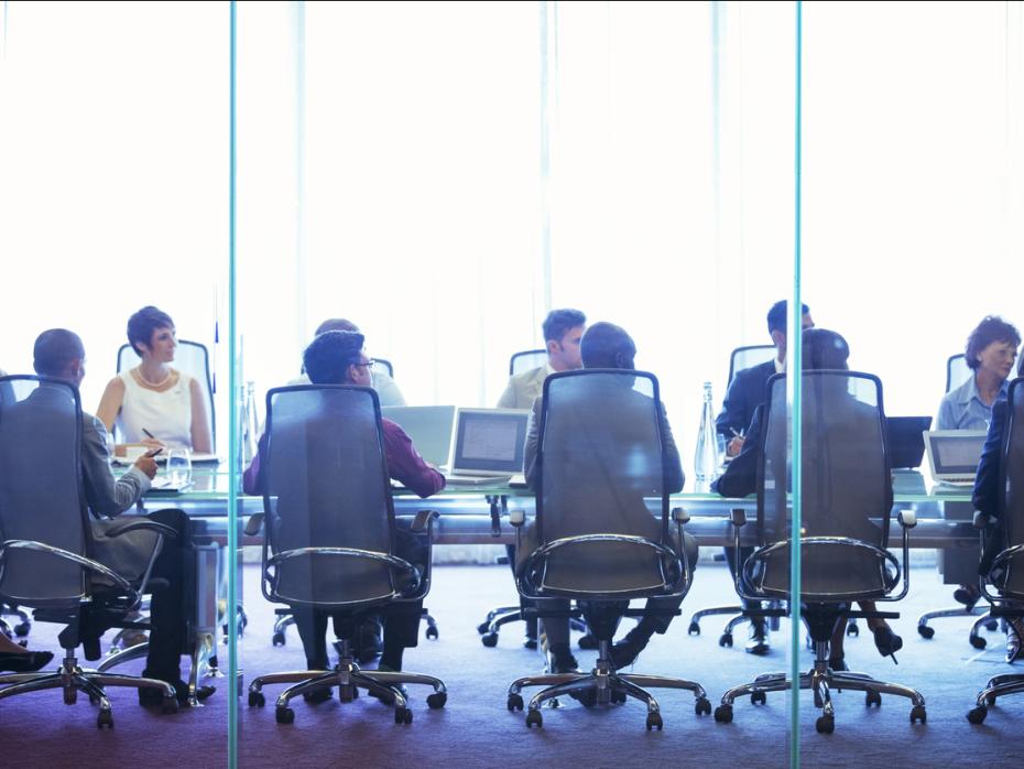 A team sat around a boardroom table