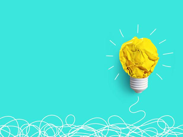 A scrunched-up piece of paper is fashioned into a lightbulb