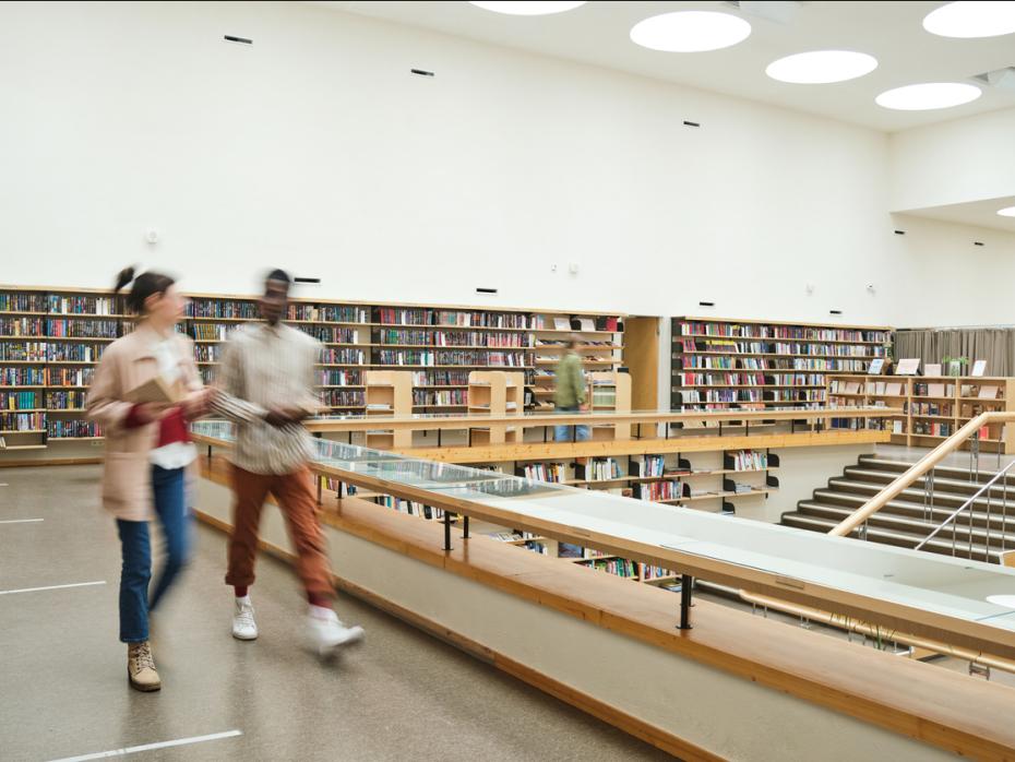 Students walking through a university library