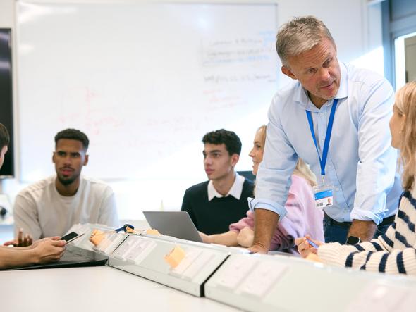 A teacher discusses with students in the classroom