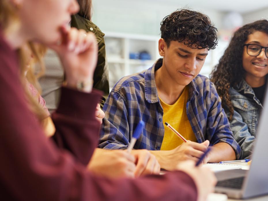 Students working at their laptops in a university classroom