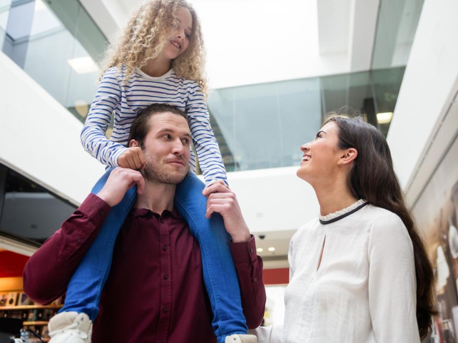 A young family walking through a university building