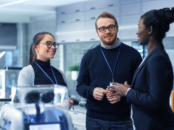 Scientists discuss a project with an investor in the lab