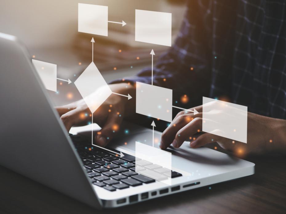 An unseen laptop user with a flow-chart visualisation superimposed